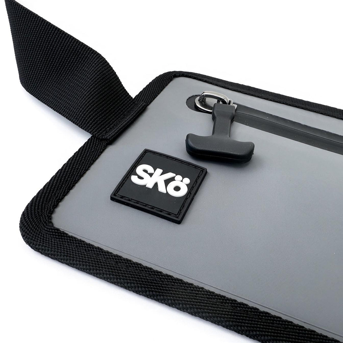 Phone Pouch in Stone Gray, close-up of the brand logo, sealed zipper and woven trim.