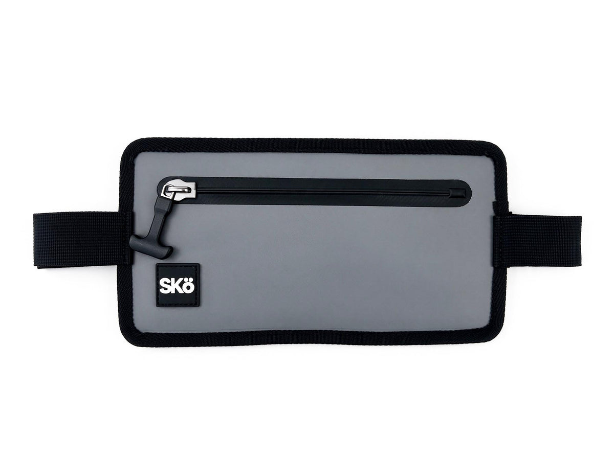 Phone Pouch in Stone Gray, front view with extended black side straps and SKÖ patch.