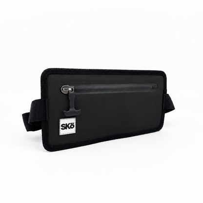Phone Pouch in Matte Black, angled front view of the SKÖ waterproof pouch with white square logo, sealed zipper and strap loops.